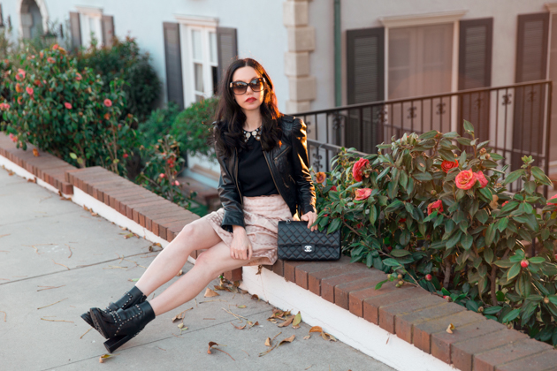 How to Dress Like a Londoner, styling tips featured by top LA fashion blog, Pretty Little Shoppers: image of a woman wearing Juicy Couture leather jacket, Alice & Olivia blouse, Anthropologie skirt, Tommy Hilfiger booties, and a Chanel bag.