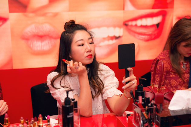 Sheree Ho tries on lipstick at Chanel Beauty House